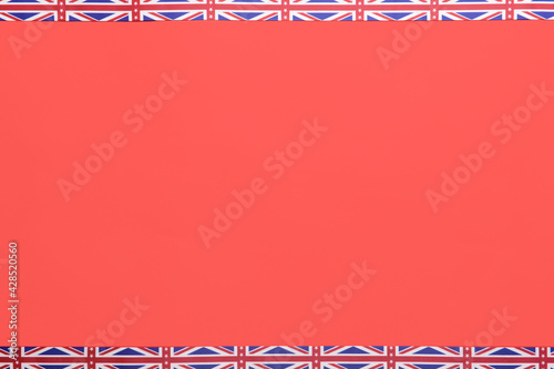 Ribbons in colors of UK flag on red background photo