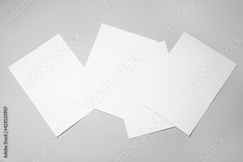 Photography Blank sheets of paper on grey background