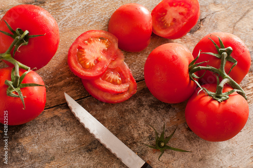 High-angle view of tomatoes on rustic wooden table © Stephen Gibson