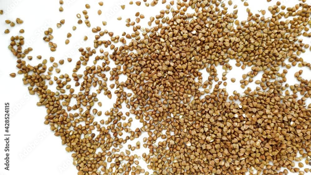 Buckwheat pouring on white background Buckwheat pouring on white background
