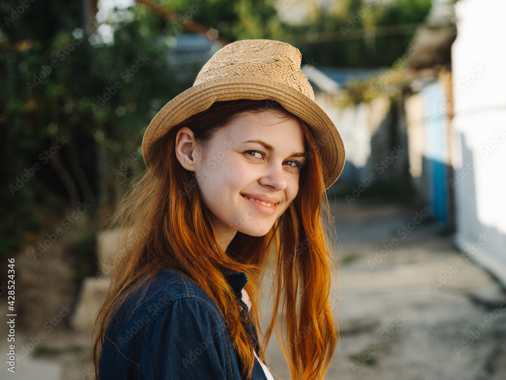 Happy woman in hat red hair shirt model countryside 