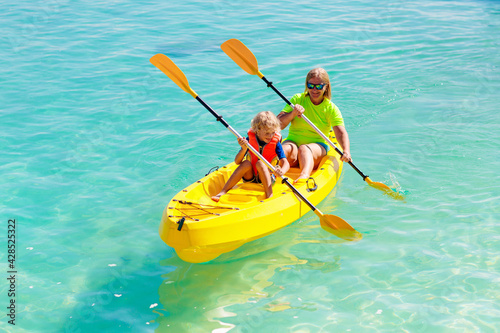 Kids kayaking in ocean. Family in kayak in tropical sea © famveldman