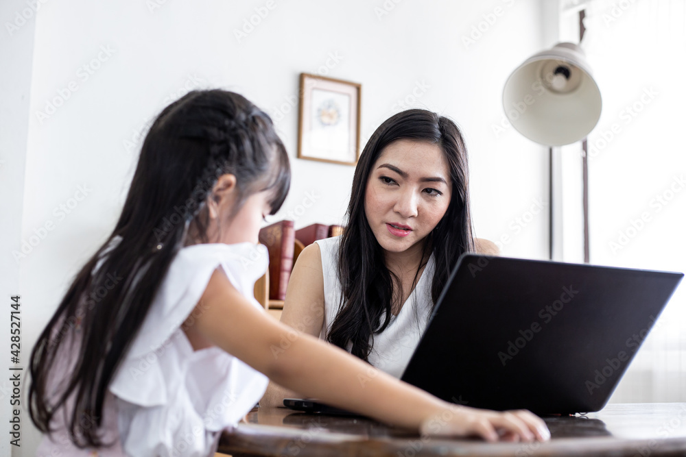 Mother and daughter playing laptop together. Mother and daughter playing laptop together.