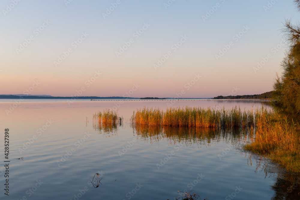 Dusk colour of a calm lake water.