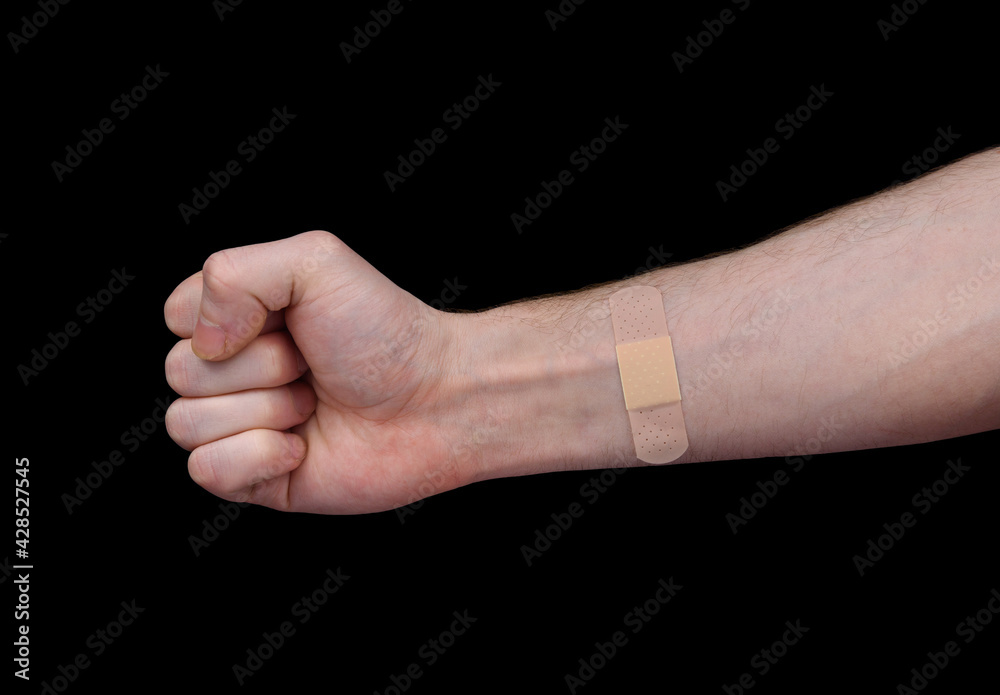 An adhesive plaster is glued to the man's forearm An adhesive plaster is glued to the man's forearm