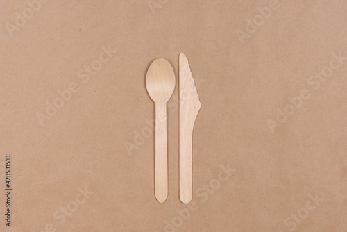 Wooden spoon and knife on craft paper