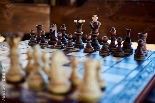 Game board with vintage wooden chess Before the battle