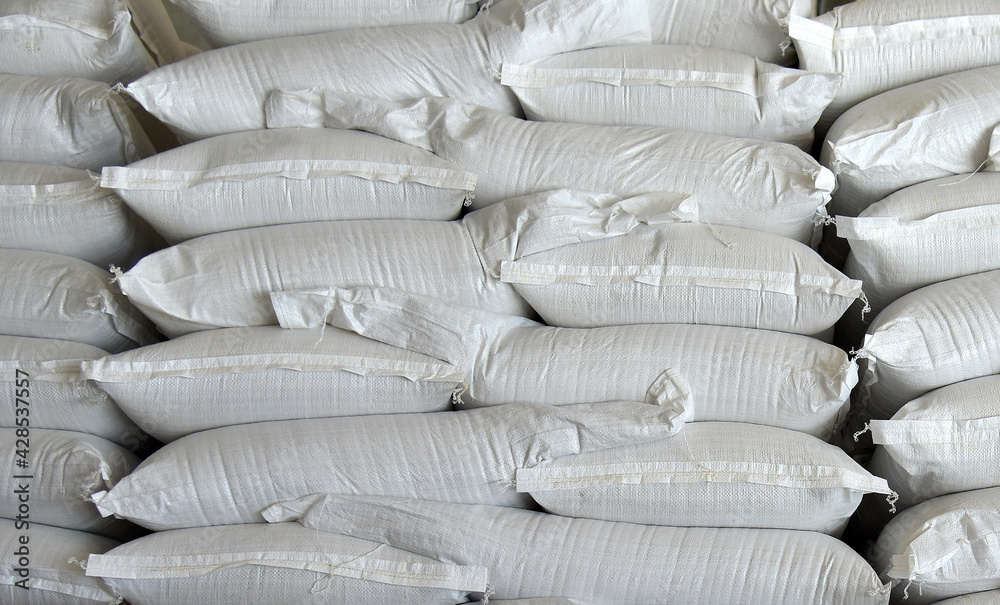 Obraz premium Bags of the ingredient are stacked on top of each other in an agricultural warehouse.
