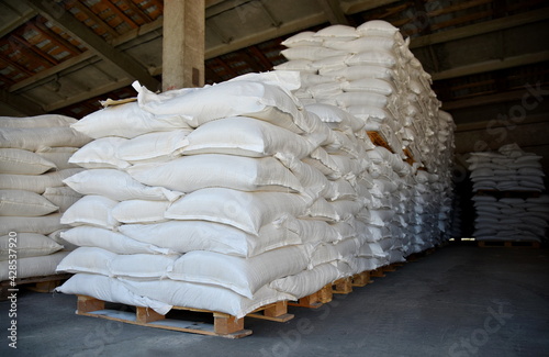 Canvas Print Large sacks of grain are stacked in the warehouse.