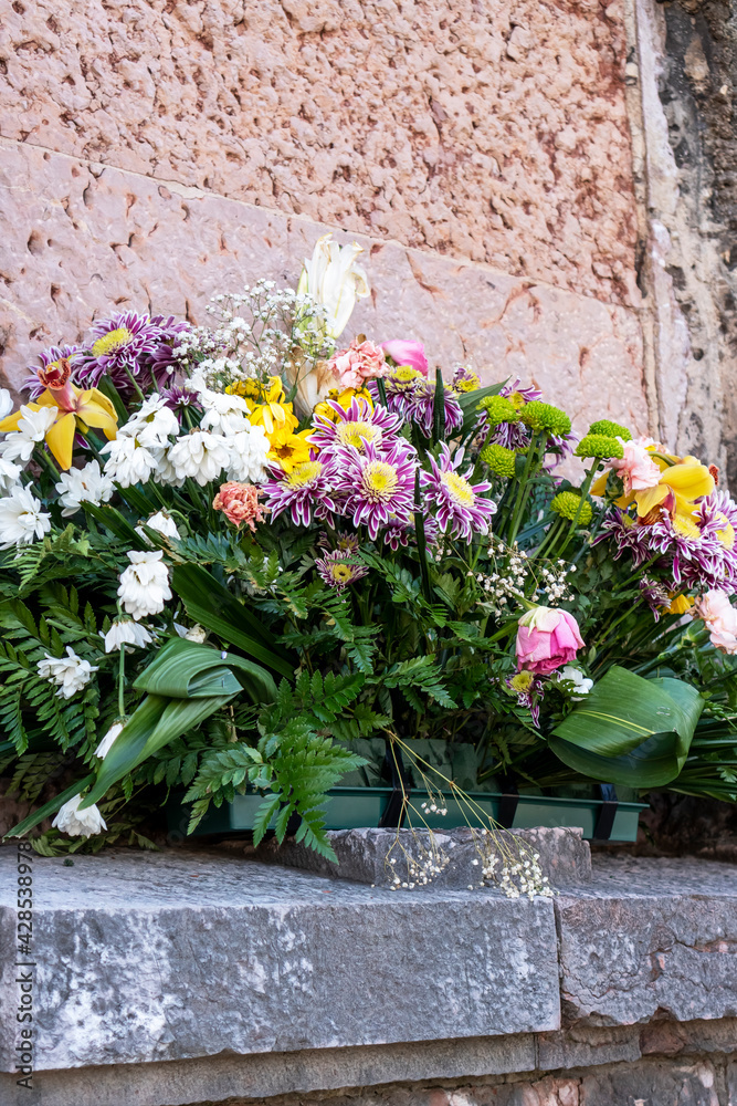 Bouquet of flowers on the old wall of the ancient church
