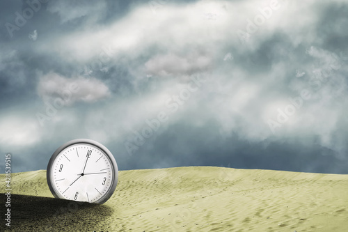 Clock in the sand dunes. Cloudy sky. Time concept. Business. Lifestyle.
