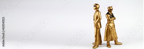Plaster figures in gold color, retro style on a light background.