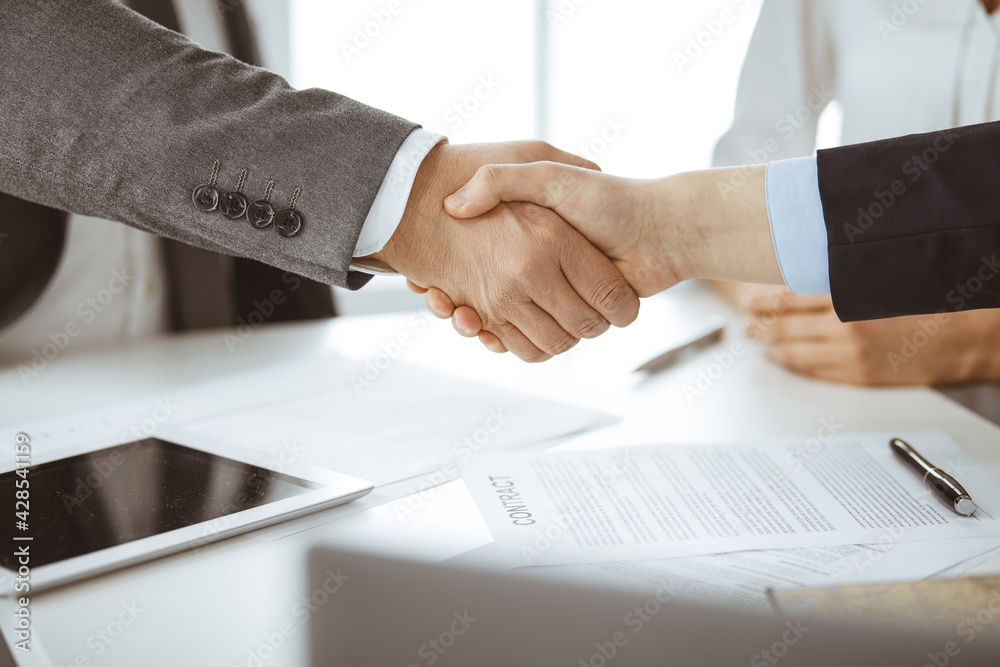 Business people shaking hands finishing contract signing, close-up. Business communication concept. Handshake and marketing