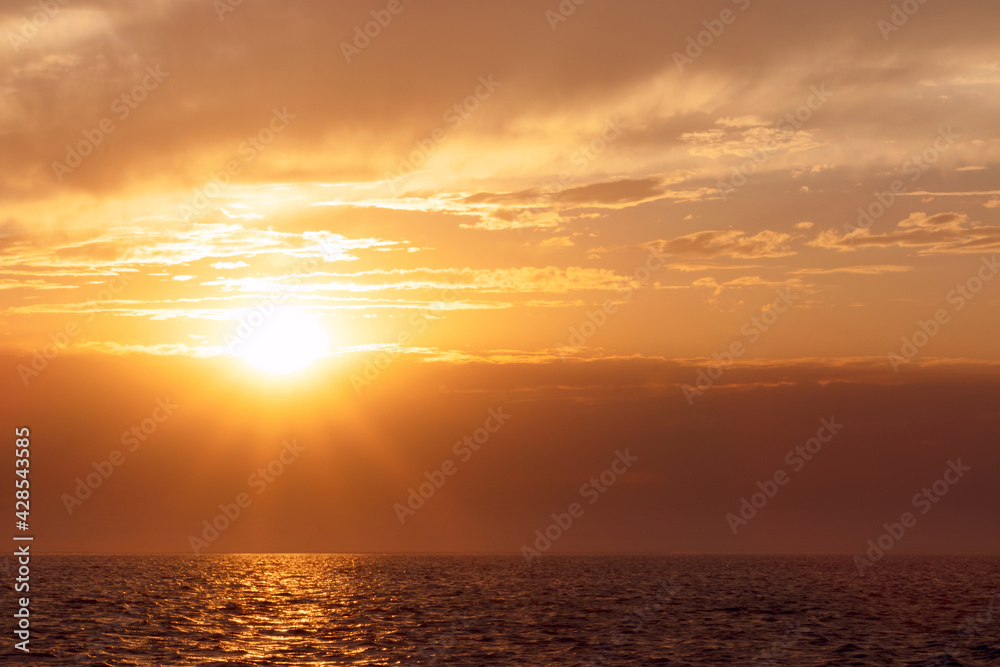 Colorful red sunset and bright sun on the horizon of the ocean beach. Colorful red sunset and bright sun on the horizon of the ocean beach.