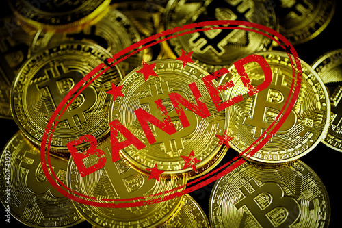pile of Bitcoin and red banned sign