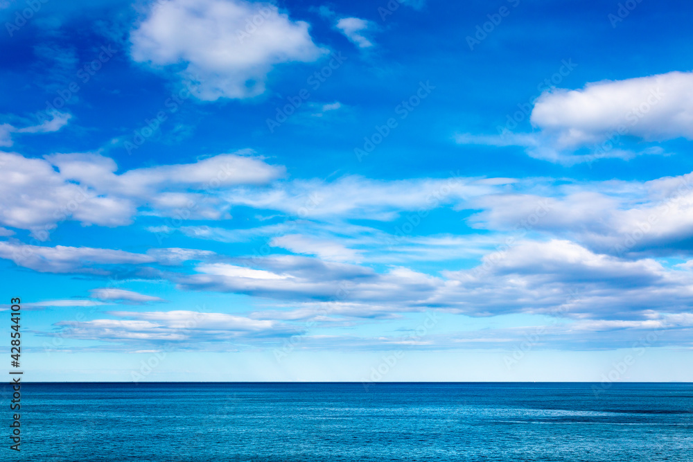 Obraz premium View to the sea and blue cloudy sky