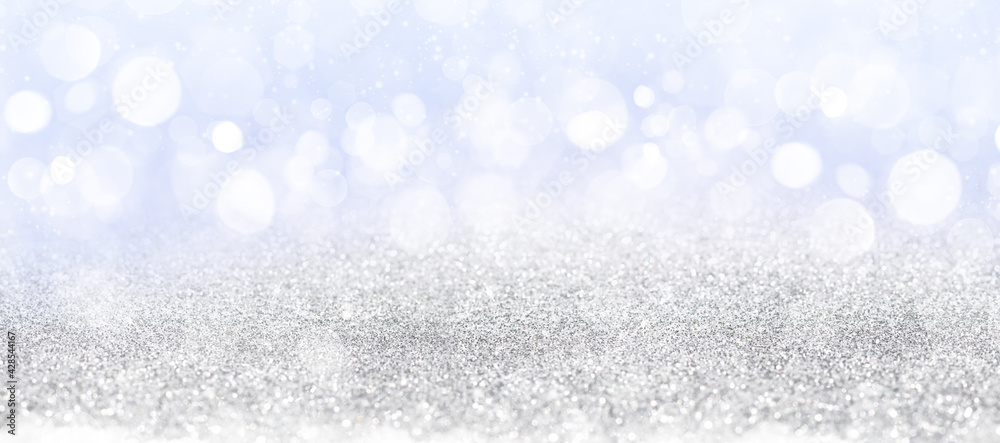 Abstract white bokeh on blue background, background design in sky blue color, sparkles and shimmery background in the shape of a circle. Abstract white bokeh on blue background, background design in sky blue color, sparkles and shimmery background in the shape of a circle.