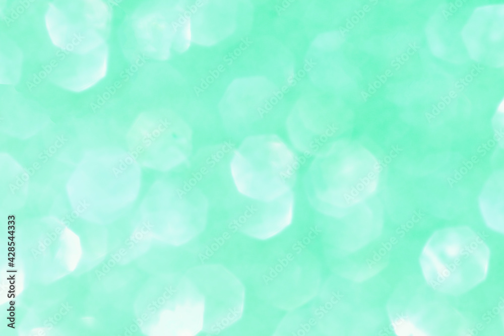 Shiny blurred green background with bokeh for a festive mood. Greeting card template for fun. Shiny blurred green background with bokeh for a festive mood. Greeting card template for fun.