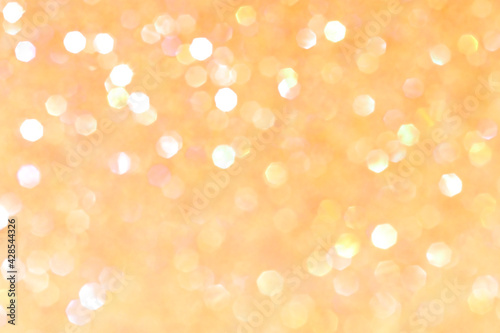Shiny blurred yellow background with bokeh for a festive mood. Greeting card template for fun.