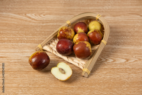 fres sliced chinese jujubes on wood background photo