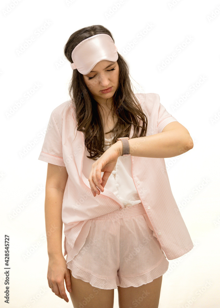 young beautiful woman brunette in pink pajamas wants to sleep young beautiful woman brunette in pink pajamas wants to sleep