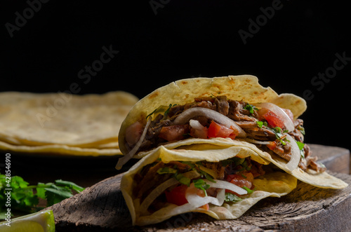 Mexican birria tacos, quesabirria with lime and chili sauce photo