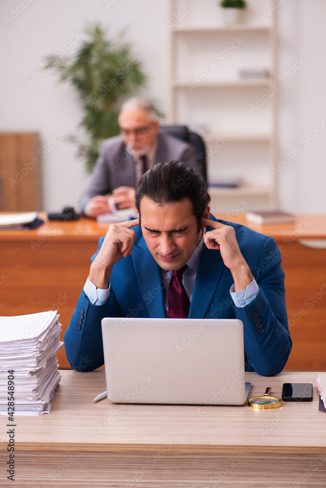 Two employees working in the office Two employees working in the office