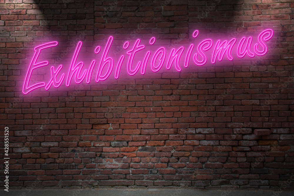 Neon exhibitionism (in german Exhibitionismus) lettering on Brick Wall at night Neon exhibitionism (in german Exhibitionismus) lettering on Brick Wall at night