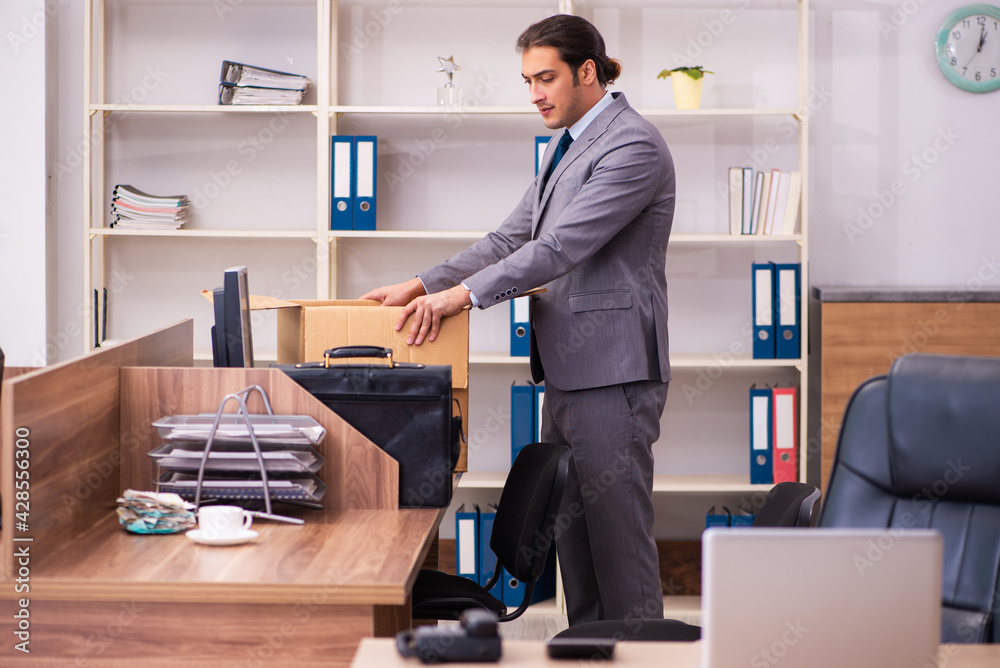 Young male employee being dismissed from his work Young male employee being dismissed from his work