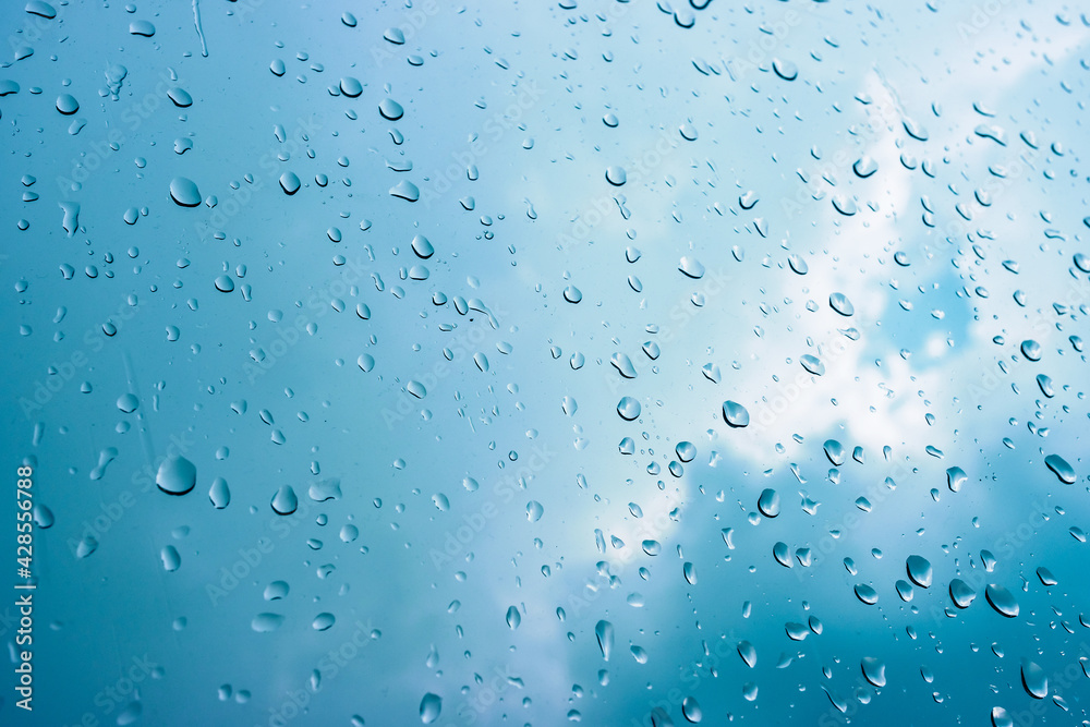 Rain drops on window glasses in rainy day with selective focusing