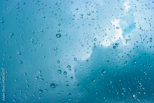 Rain drops on window glasses in rainy day with selective focusing