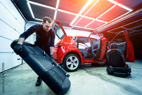 Car service worker disassemble the interior of the car