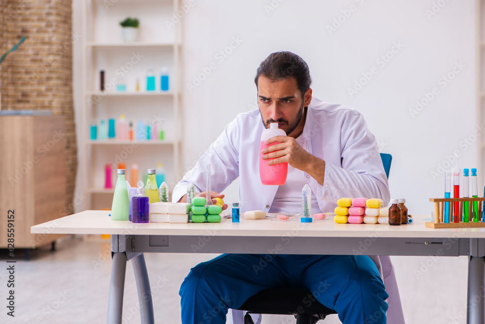 Young male chemist testing soap in the lab Young male chemist testing soap in the lab
