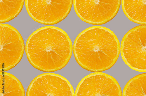 Orange Fruit slice Background. Healthy food lifestile. Food trendy yellow gray background. Applicable for fruit juice advertising. Frame, border. Copy space for text. Summer concept.