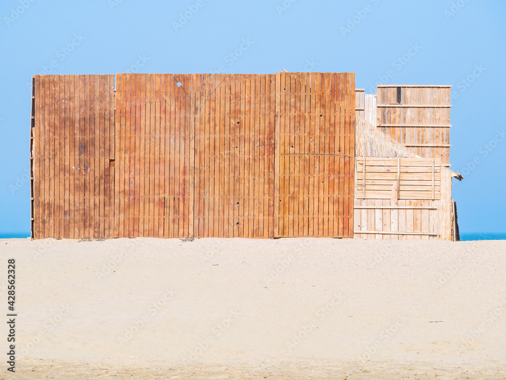 Fototapeta premium Wooden construction on the beach in Constanta Romania. Summer beach vacation landscape