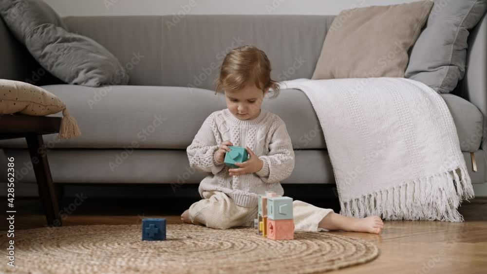 Litle cute child enjoy and concentrate playing colored blocks, Slow Motion. Learning through play is an important part of a child’s development. Child Development Concept. Litle cute child enjoy and concentrate playing colored blocks, Slow Motion. Learning through play is an important part of a child’s development. Child Development Concept.