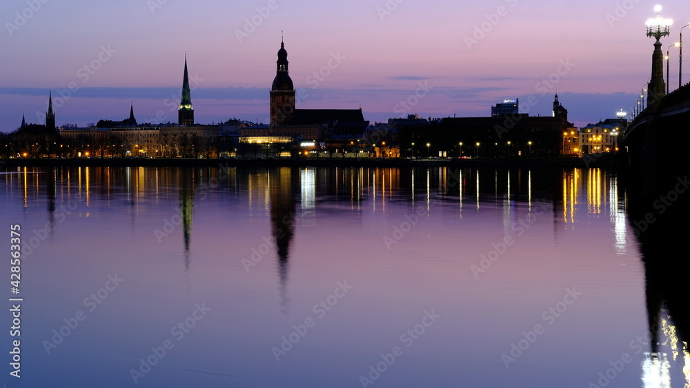 Fototapeta premium Spring sunrise over old Riga reflected in the mirror of the Daugava