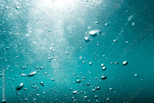 Underwater View of Bubbles In Deep Blue Sea. Close Up Water. Background