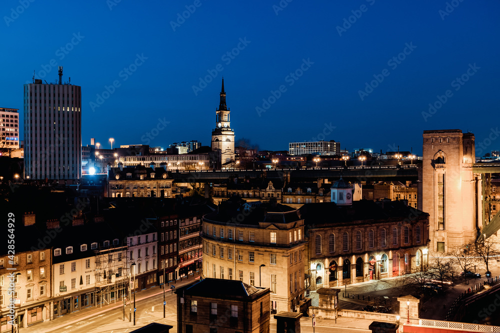 Fototapeta premium Newcastle upon Tyne UK: 30th March 2021: Newcastle Skyline at night with deep blue sky