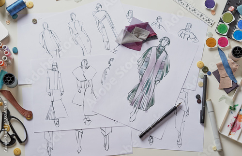 Fashion designer stylish drawings sketches textile fabric material Costume. Designer creative workshop studio. photo