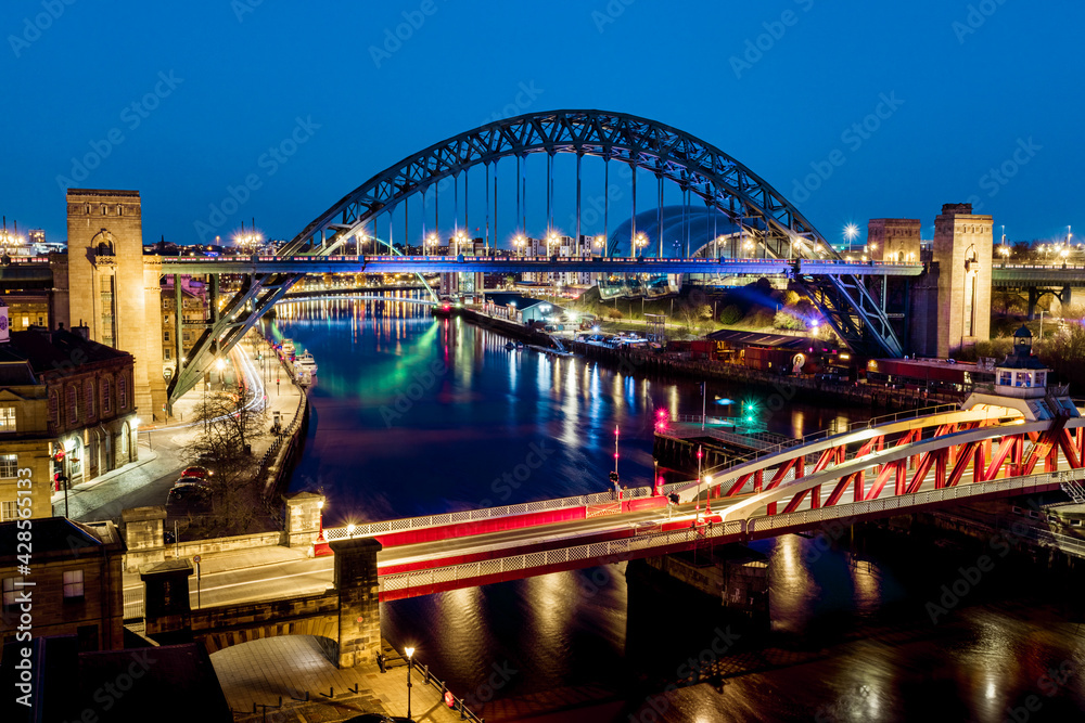 Newcastle upon Tyne UK: 30th March 2021: Newcastle Gateshead Quayside at night, with of Tyne Bridge and city skyline, long exposure during blue hour