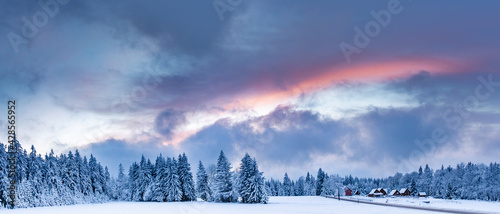 Fototapeta Naklejka Na Ścianę i Meble -  Spalona, winter landscape with colorful clouds illuminated by the setting sun.