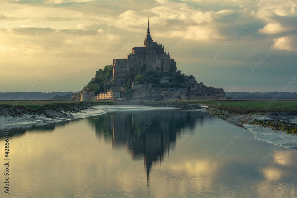The Mont Saint Michel and its bay at the sunset 