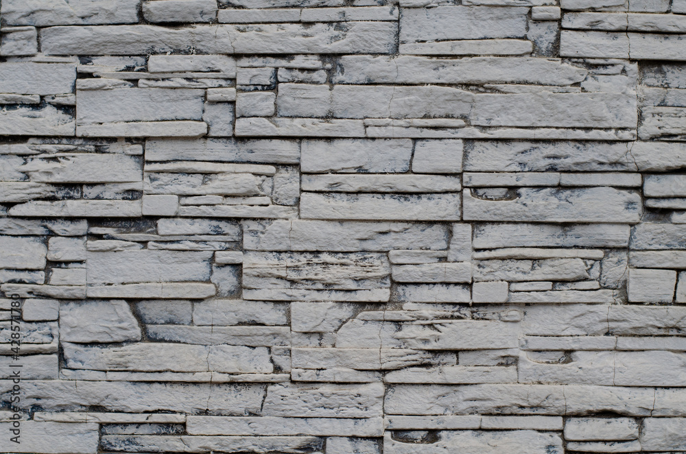 Fototapeta premium Decorative tiles. The structure of the stone. A wall of stones.