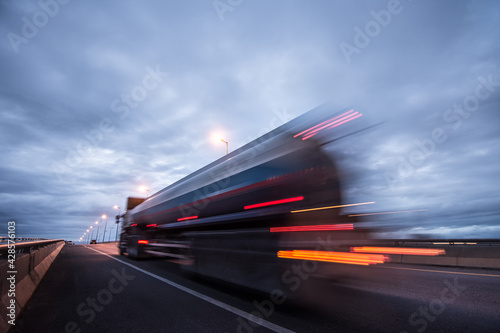 Blurred motion truck on the road with Sunset