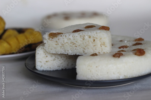 Spongy steamed rice cakes prepared with a fermented batter of rice and coconut served with steamed plantain.
