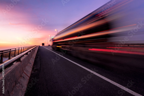 Blurred motion truck on the road with Sunset