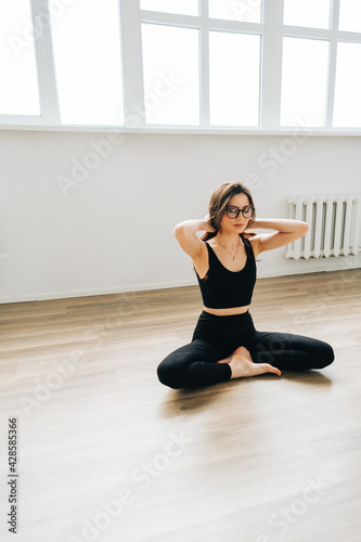Beautiful brunette fitness woman meditate  doing yoga indoors at home. Staying fit and healthy