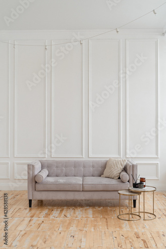 a bright space with white walls, high ceilings and wooden floors.