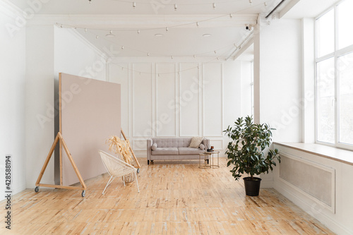 a bright space with white walls, high ceilings and wooden floors.
